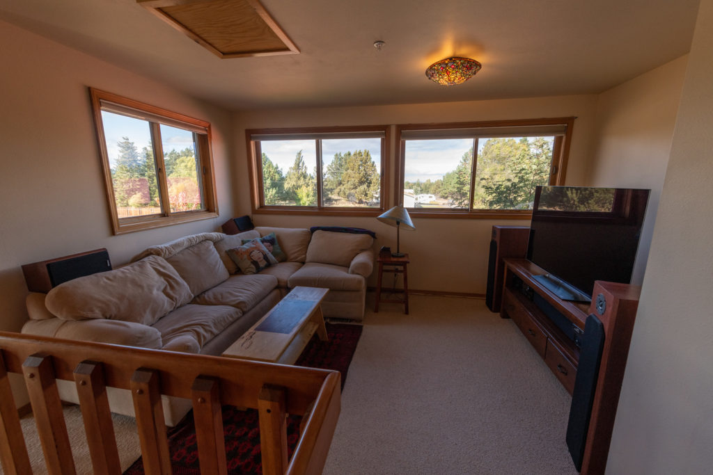 Enjoy a movie or just the views from this loft while living is this furnished Bend short term rental.