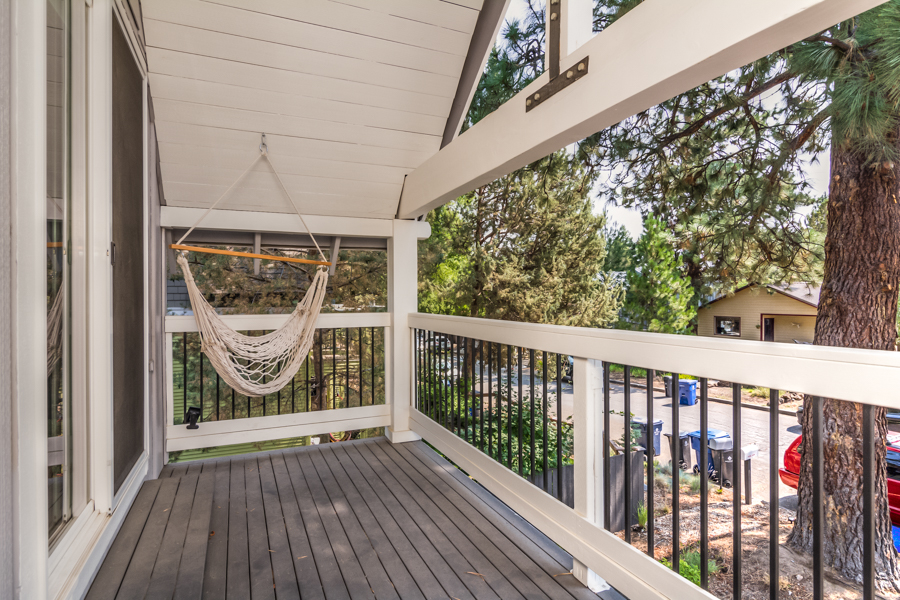 The primary bedroom of this rental on the west side of Bend has a covered deck.