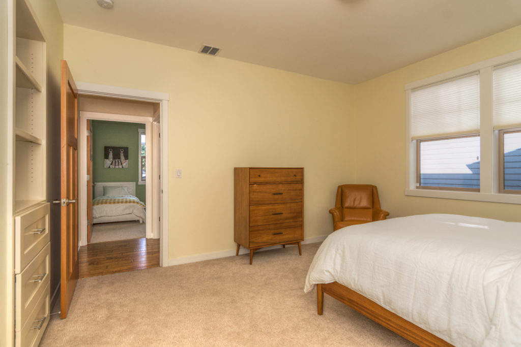 bedroom with queen bed in furnished executive rental in Northwest Crossing