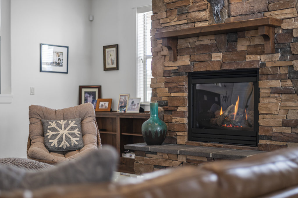 gas fireplace in the living room of this furnished home in Bend