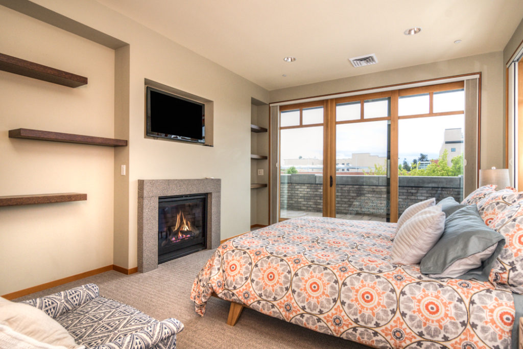 Primary bedroom with gas fireplace in downtown Bend executive rental
