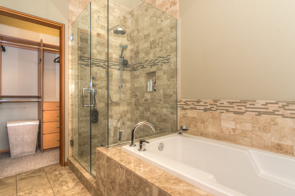Primary bathroom with soaking tub and walk in showrer