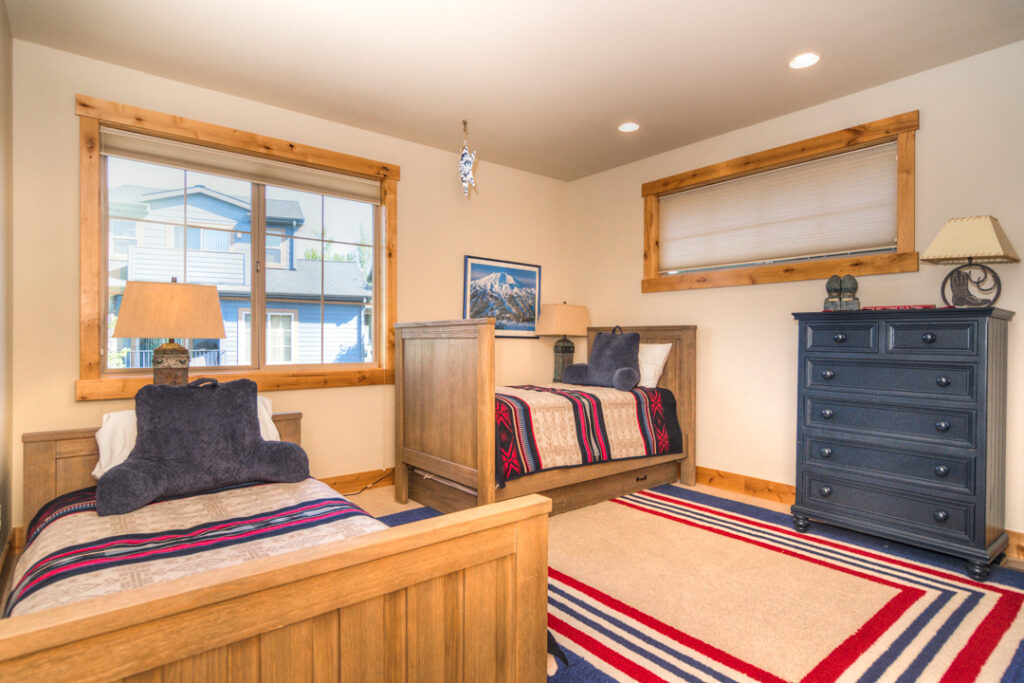 Two twin beds in the second level bedroom of this Old Mill river rental