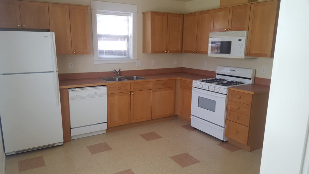 Kitchen in this midtown Bend rental includes refrigerator, stove, dishwasher and microwave.