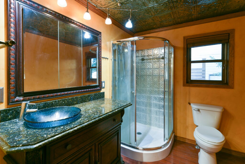 The walk in shower in the primary bathroom has a glass surround