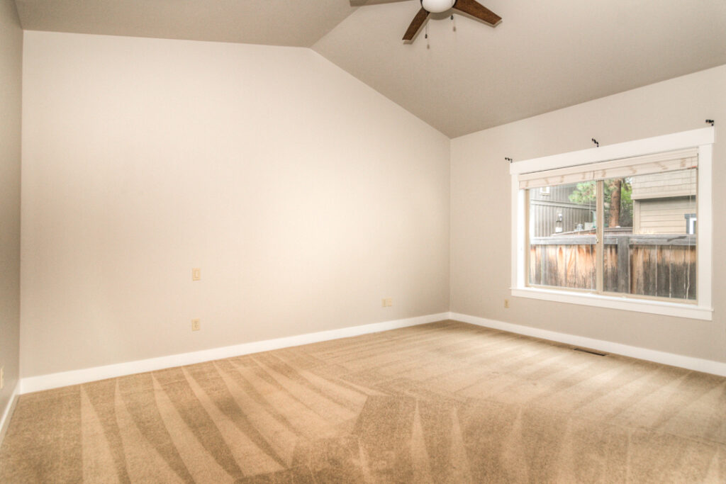 The primary bedroom of this rental is quite large and has vaulted ceilings and a ceiling fan.