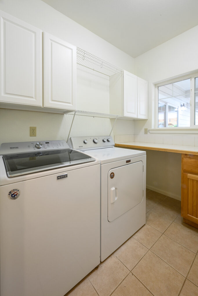Laundry room with washer and dryer included in this Redmond rental with an office