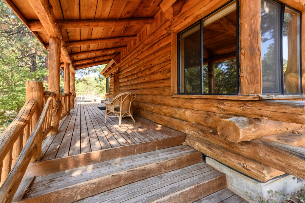 Big front porch on this furnished log home rental in Bend