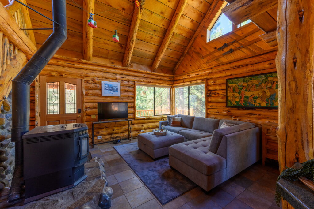 There is lots of natural light in the living room of this furnished log home rental in Bend